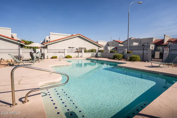 a swimming pool view with a outdoor seating space