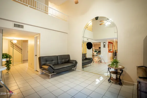 a living room with furniture and a mirror