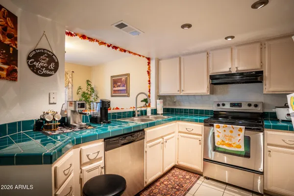 a kitchen with stainless steel appliances granite countertop a stove a sink and a microwave