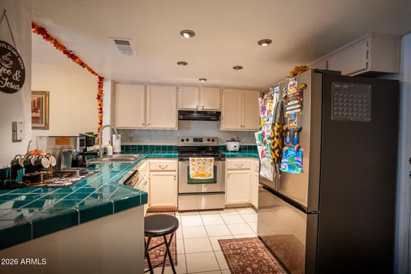 a kitchen with stainless steel appliances granite countertop a refrigerator and a stove