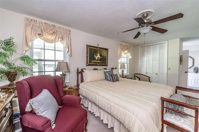 a bedroom with a bed couch and window