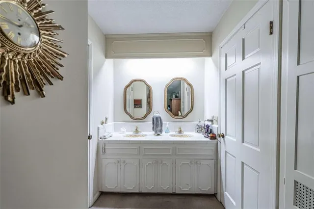 a bathroom with a sink a vanity and a mirror