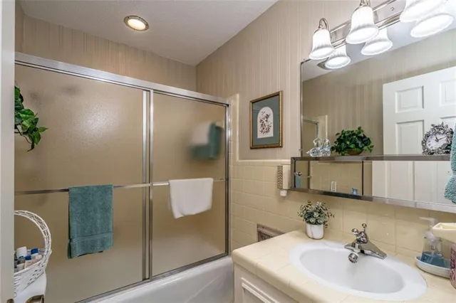a bathroom with a sink mirror and vanity