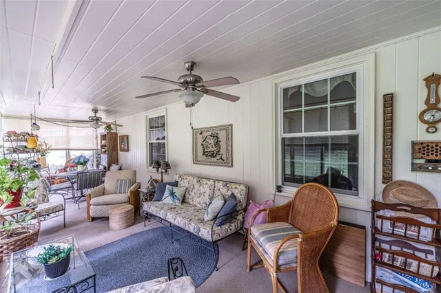 a living room with furniture a chandelier and a window