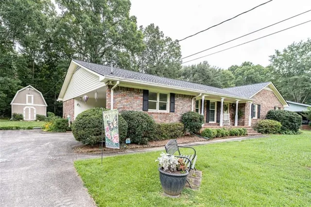 a front view of house with yard and outdoor seating