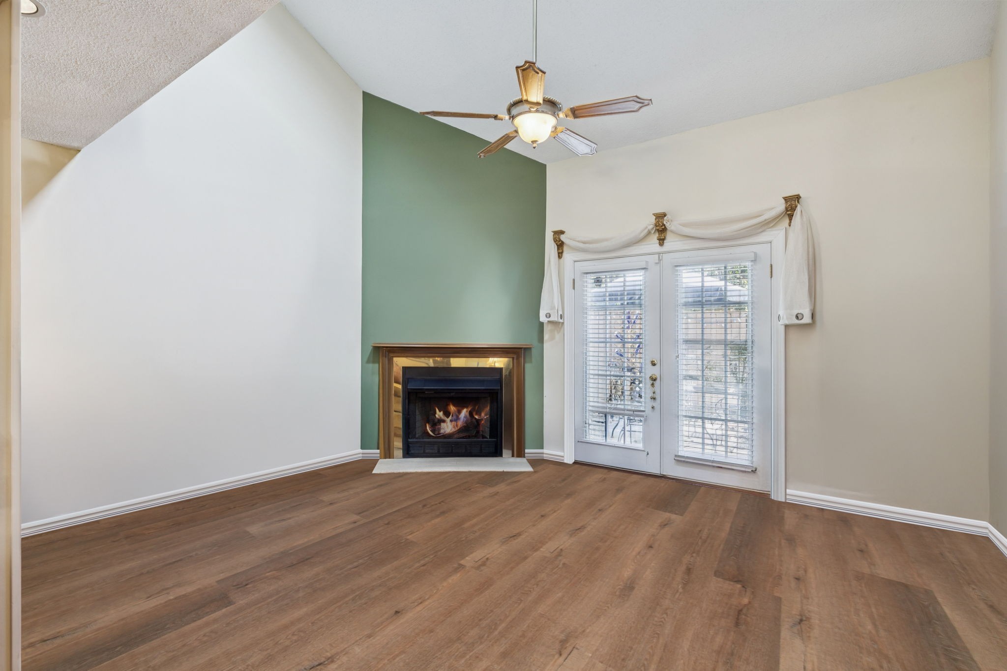 357 Yorkshire Circle Nashville, TN 37211 - Photo 5 of 44 an empty room with wooden floor fireplace and fan