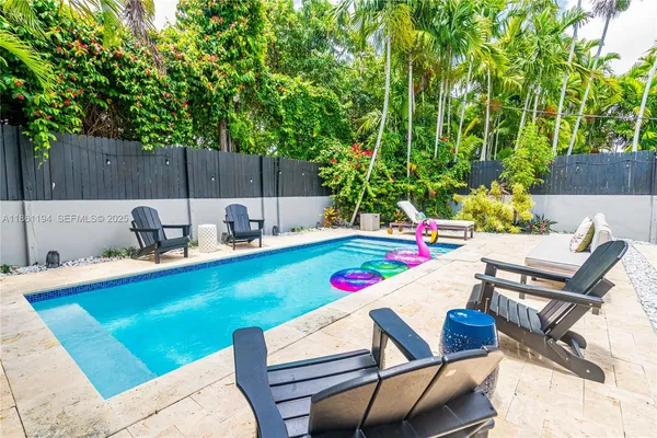 a view of outdoor sitting area with furniture and wooden fence