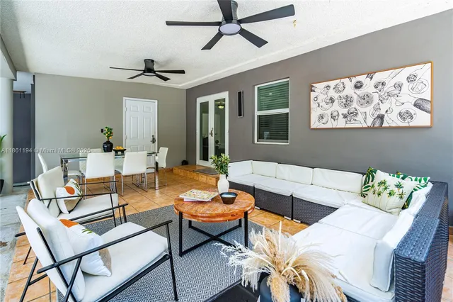 a living room with furniture a rug and a mirror