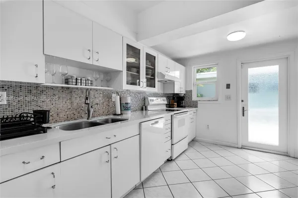 a bedroom with two beds and painting on the wall