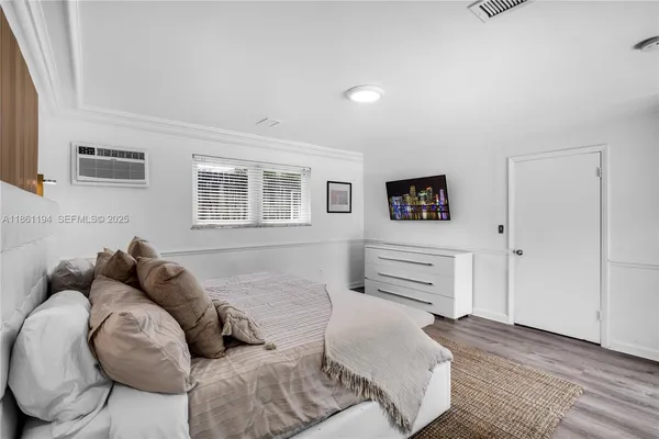 a bedroom with a large bed and a window