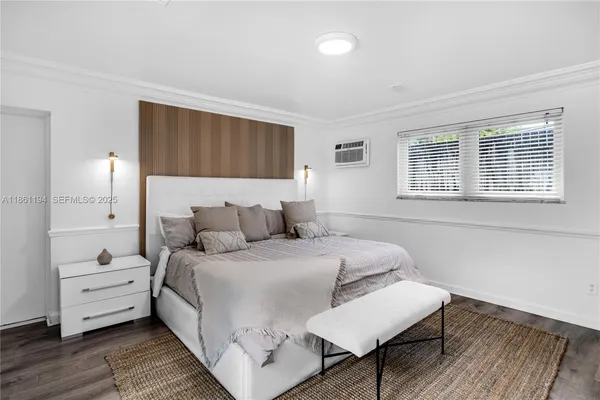 a bedroom with furniture and a window