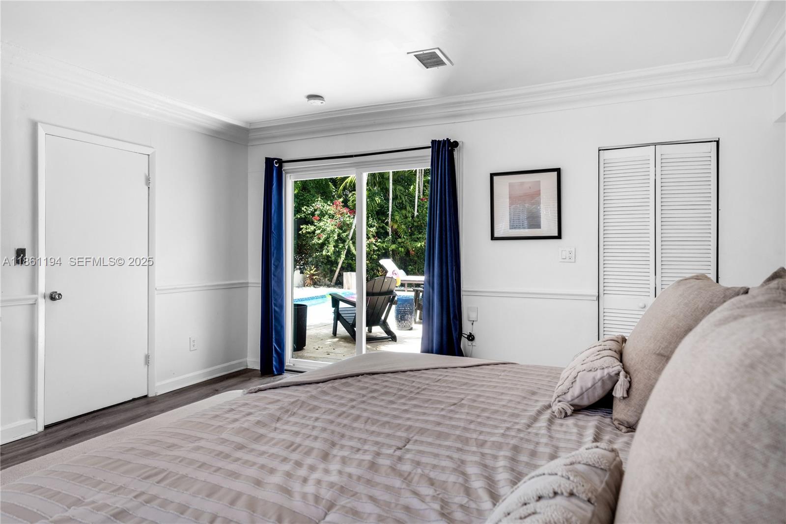 520 Southwest 22nd Road Miami, FL 33129 - Photo 32 of 71 a bedroom with a bed and a large window