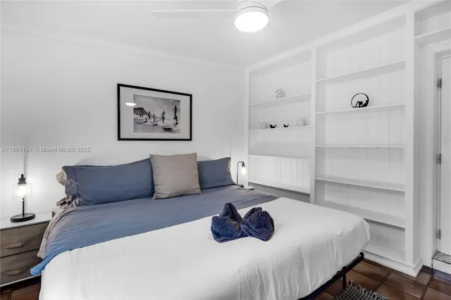 a bedroom with a bed and a lamp