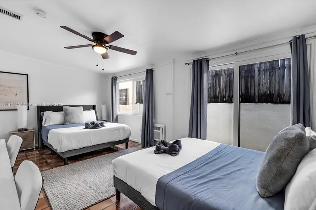 a view of a room with a large window and wooden floor