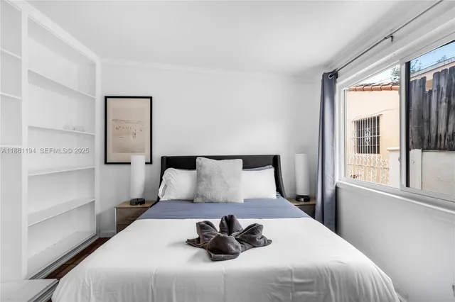 a bedroom with a bed and a lamp