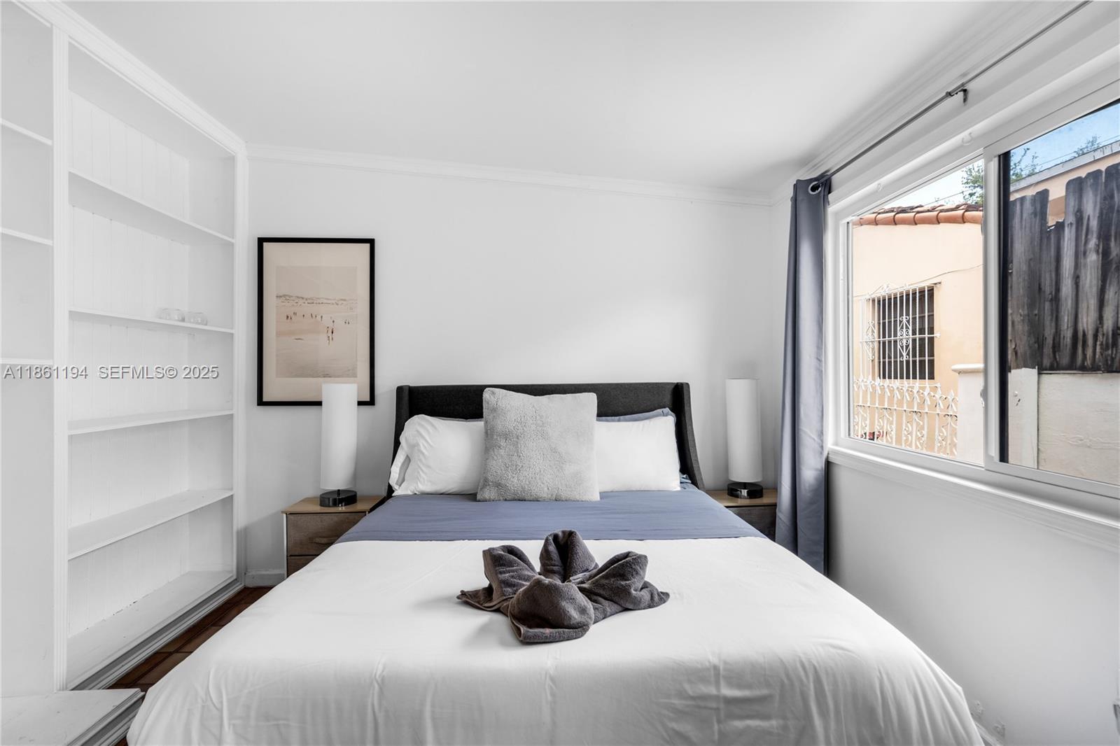 520 Southwest 22nd Road Miami, FL 33129 - Photo 40 of 71 a bedroom with a large bed and a window