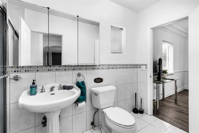 a utility room with cabinets washer and dryer