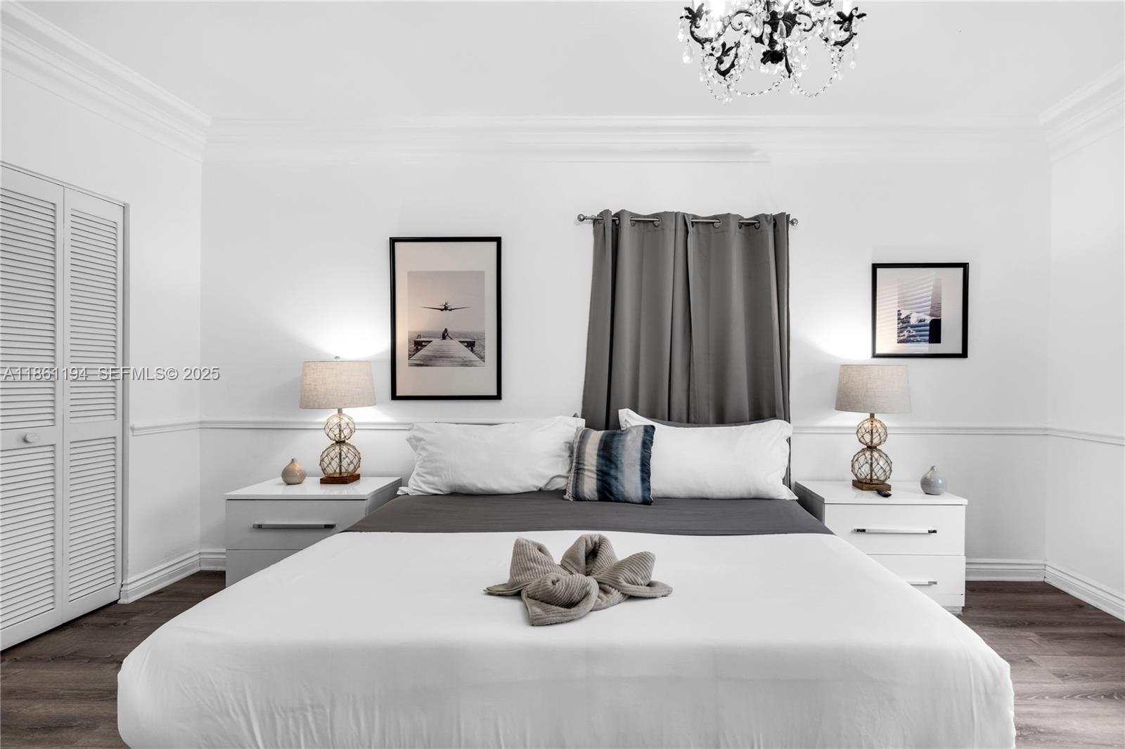 520 Southwest 22nd Road Miami, FL 33129 - Photo 46 of 71 a bedroom with a bed and a painting on the wall