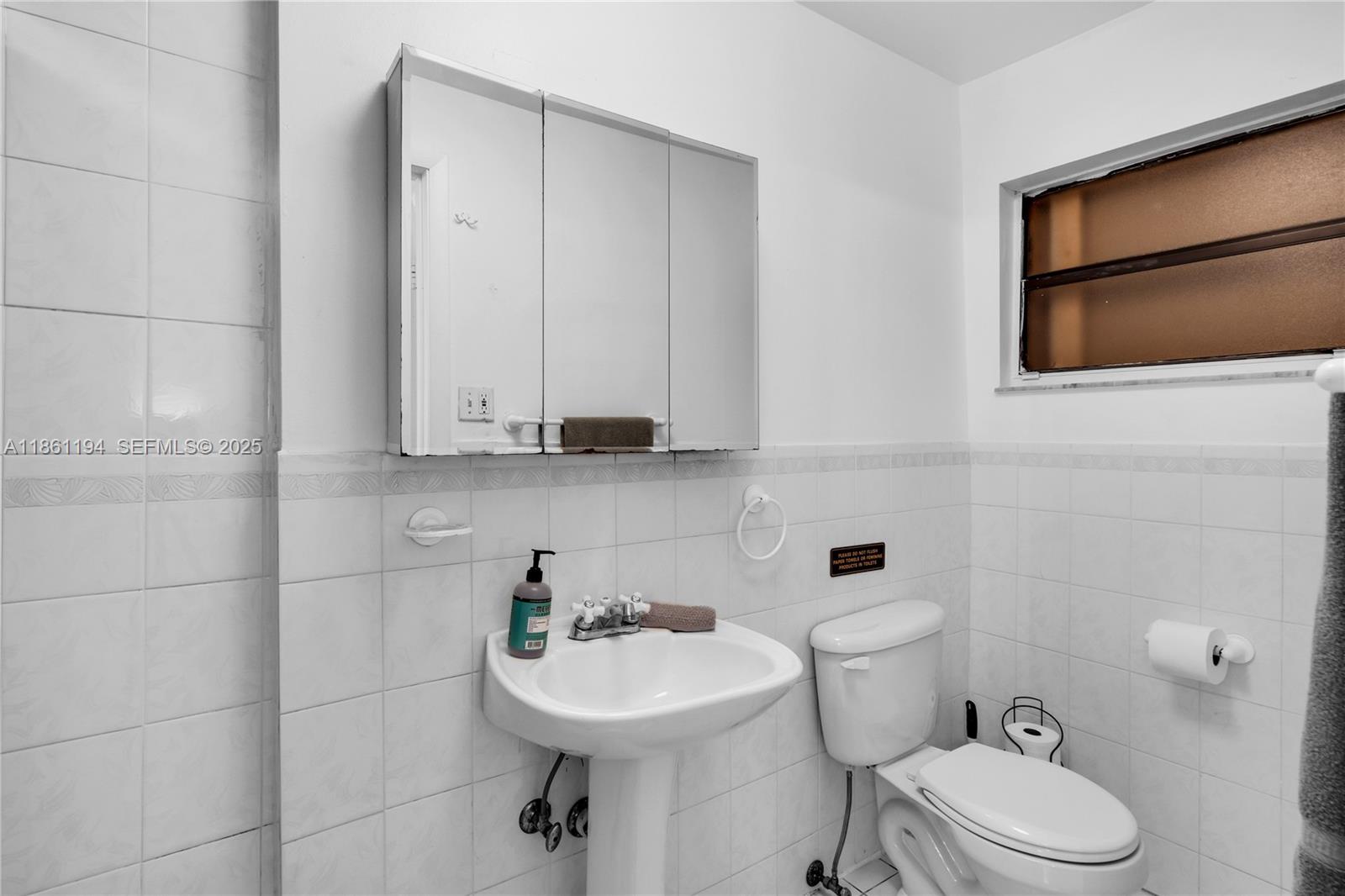 520 Southwest 22nd Road Miami, FL 33129 - Photo 49 of 71 a bathroom with a sink a toilet and mirror