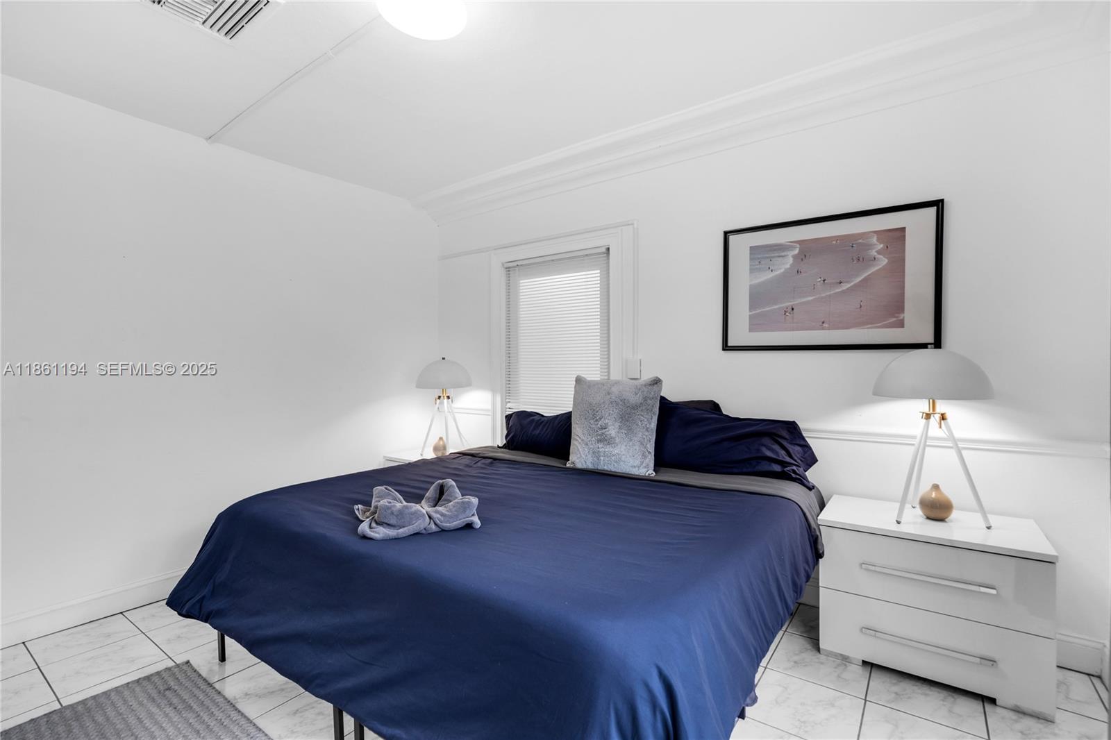 520 Southwest 22nd Road Miami, FL 33129 - Photo 52 of 71 a bedroom with a bed and a lamp