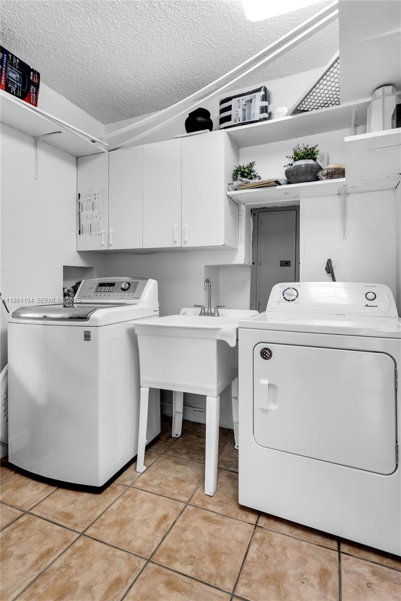 520 Southwest 22nd Road Miami, FL 33129 - Photo 63 of 71 a utility room with cabinets washer and dryer