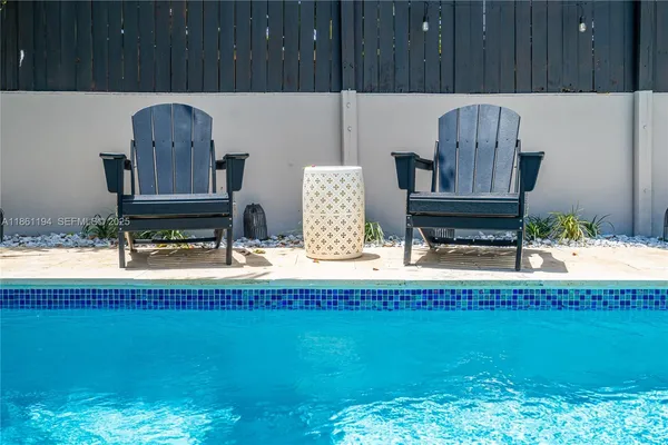 a living room with furniture a ceiling fan and a window