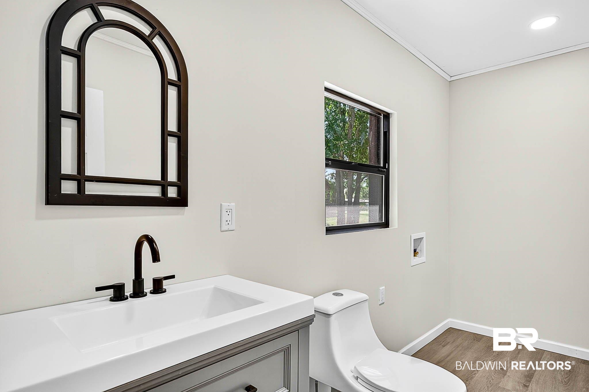 101 Terry Avenue Brewton, AL 36426 - Photo 36 of 48 Bathroom with vanity, wood finished floors, and crown molding