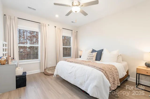 a bedroom with a bed and wooden floor