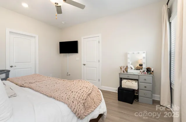 a bedroom with a bed and a television