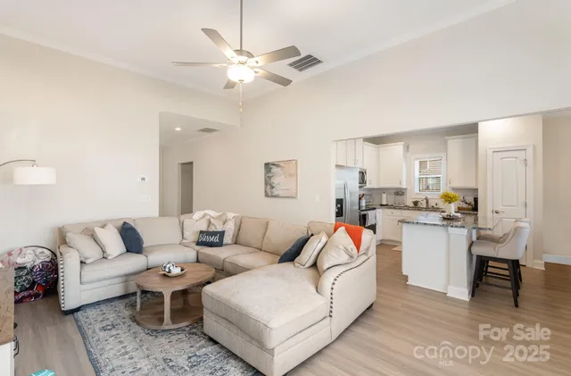a living room with furniture and kitchen view