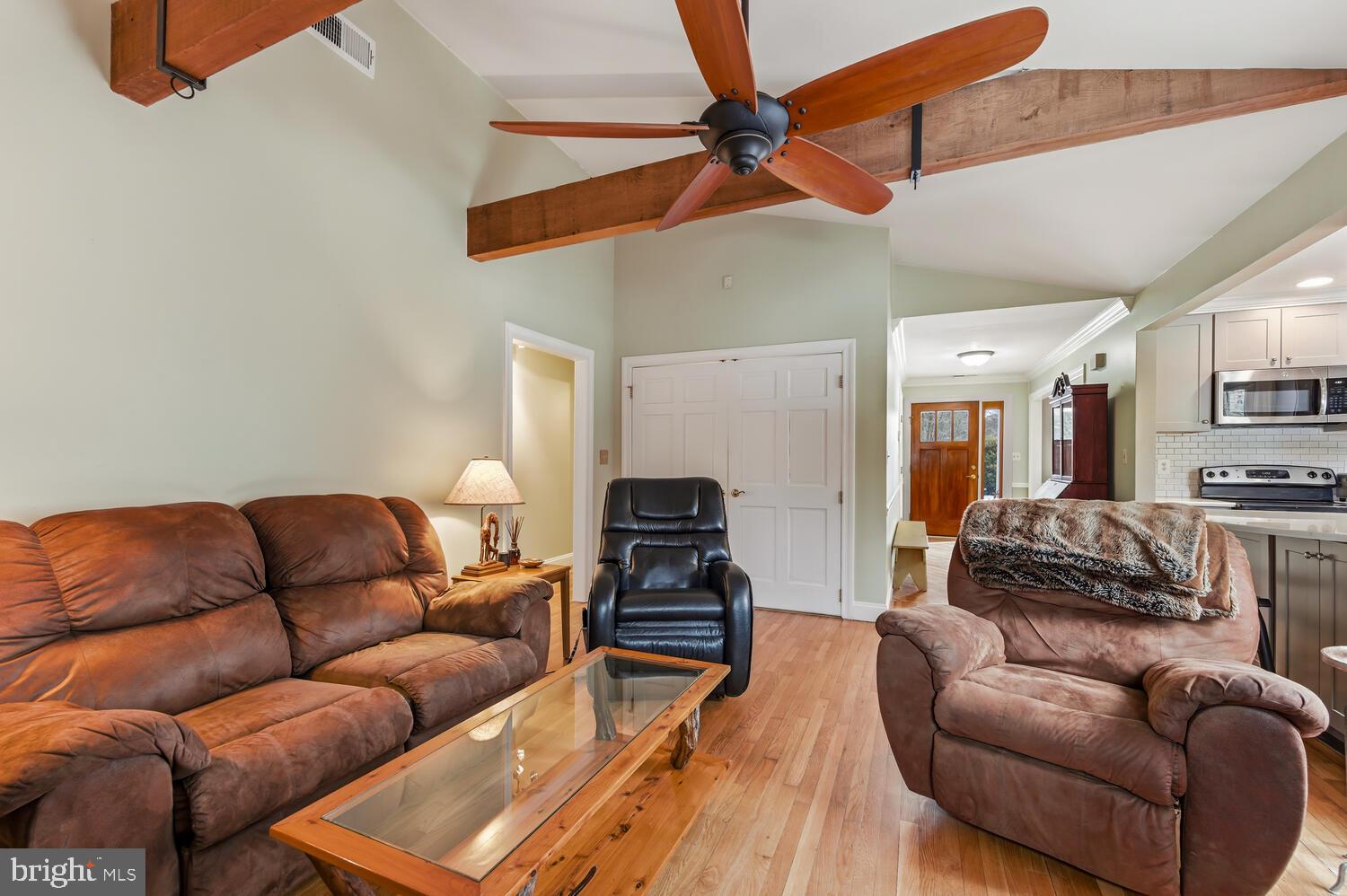 25706 Edgeview Road Royal Oak, MD 21662 - Photo 11 of 31 a living room with furniture kitchen view and a wooden floor