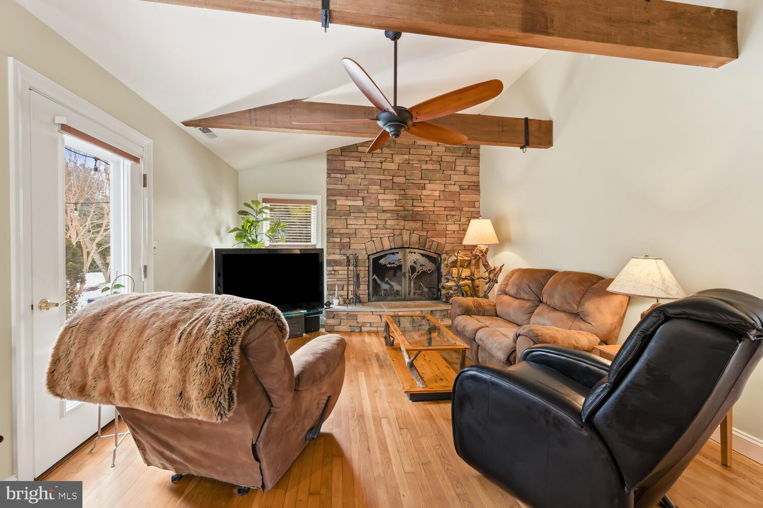 25706 Edgeview Road Royal Oak, MD 21662 - Photo 12 of 31 a living room with furniture a fireplace and a flat screen tv