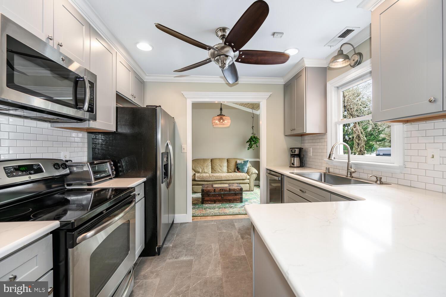25706 Edgeview Road Royal Oak, MD 21662 - Photo 15 of 31 a kitchen with stainless steel appliances granite countertop a stove sink microwave and refrigerator