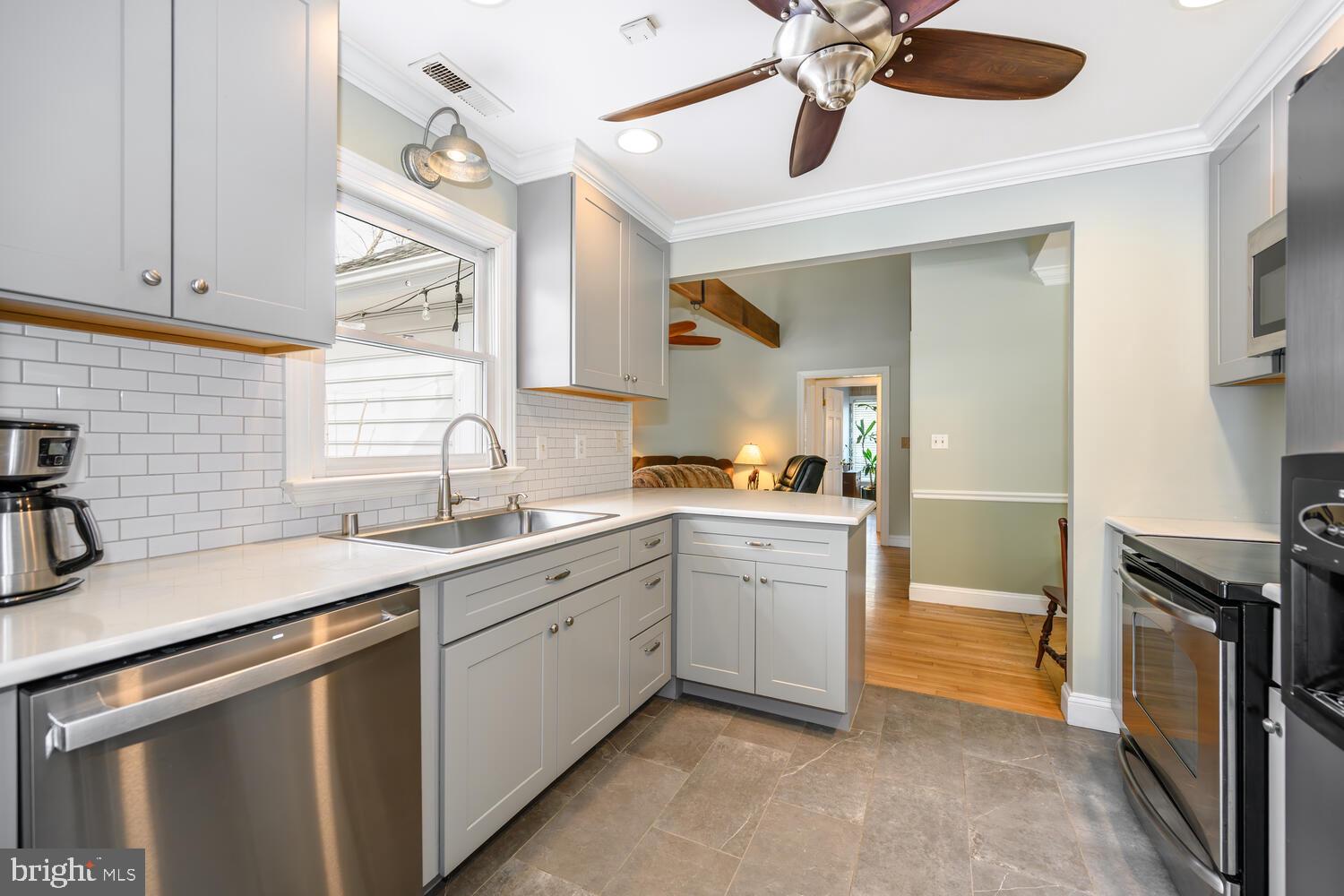 25706 Edgeview Road Royal Oak, MD 21662 - Photo 16 of 31 a kitchen with a sink dishwasher a stove and a refrigerator with wooden floor