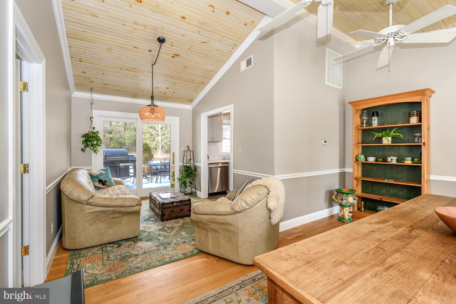 25706 Edgeview Road Royal Oak, MD 21662 - Photo 19 of 31 a living room with furniture a flat screen tv and a large window