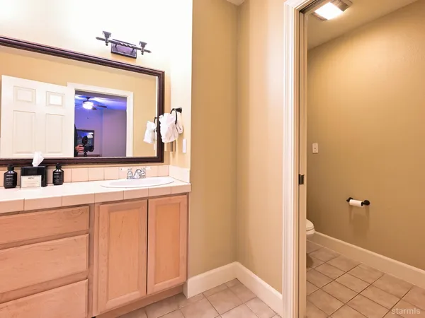 a bathroom with a sink mirror vanity and toilet