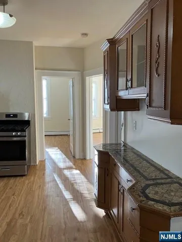 a kitchen with granite countertop a stove and a refrigerator