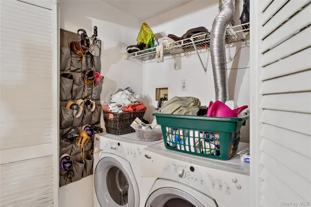 a view of a storage & utility room with two washing machine
