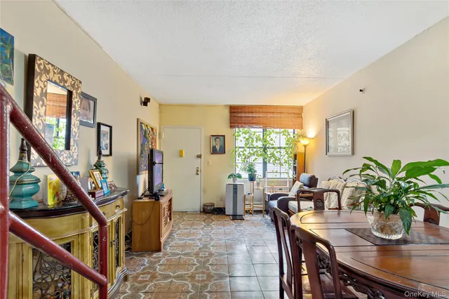 a dining room with furniture and potted plants
