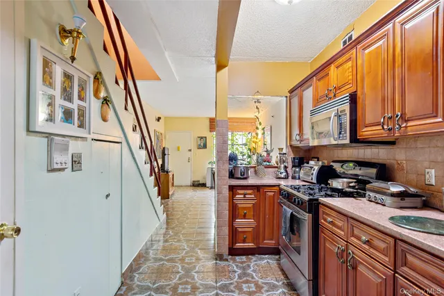 a kitchen with a sink a stove and cabinets