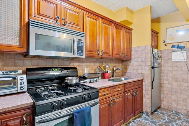 a kitchen with stainless steel appliances granite countertop a stove and a microwave