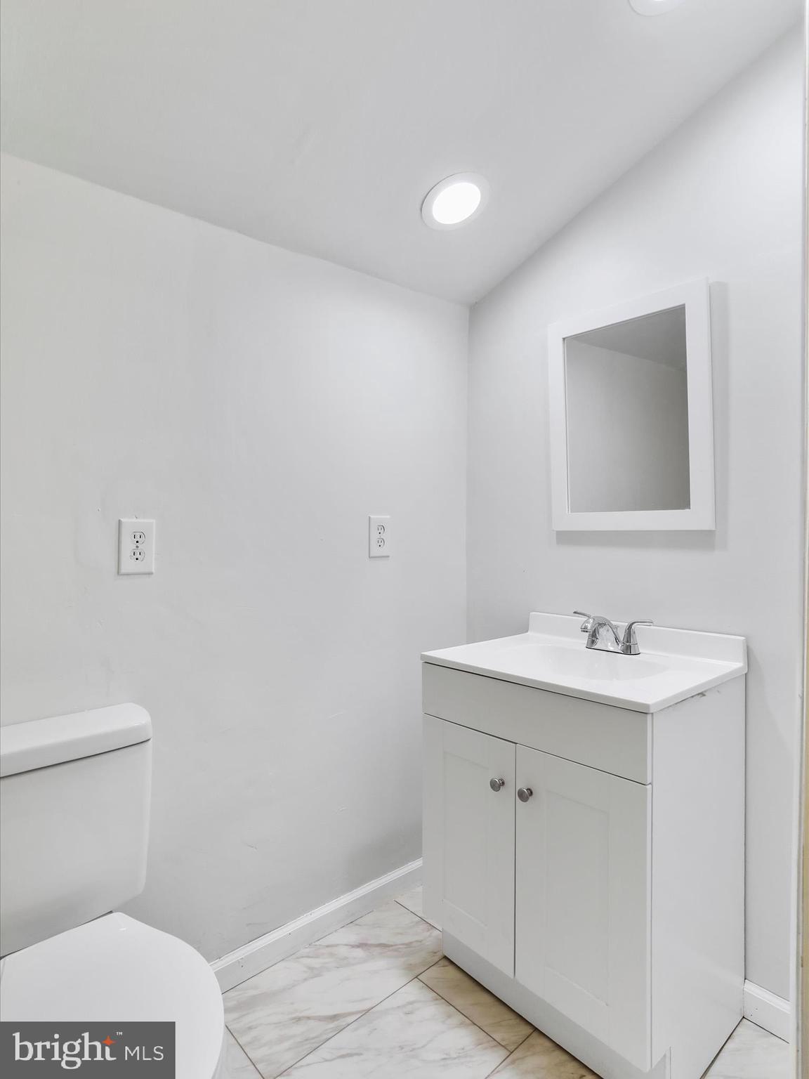 409 South Raleigh Street Martinsburg, WV 25401 - Photo 13 of 28 a bathroom with a sink a toilet and a mirror