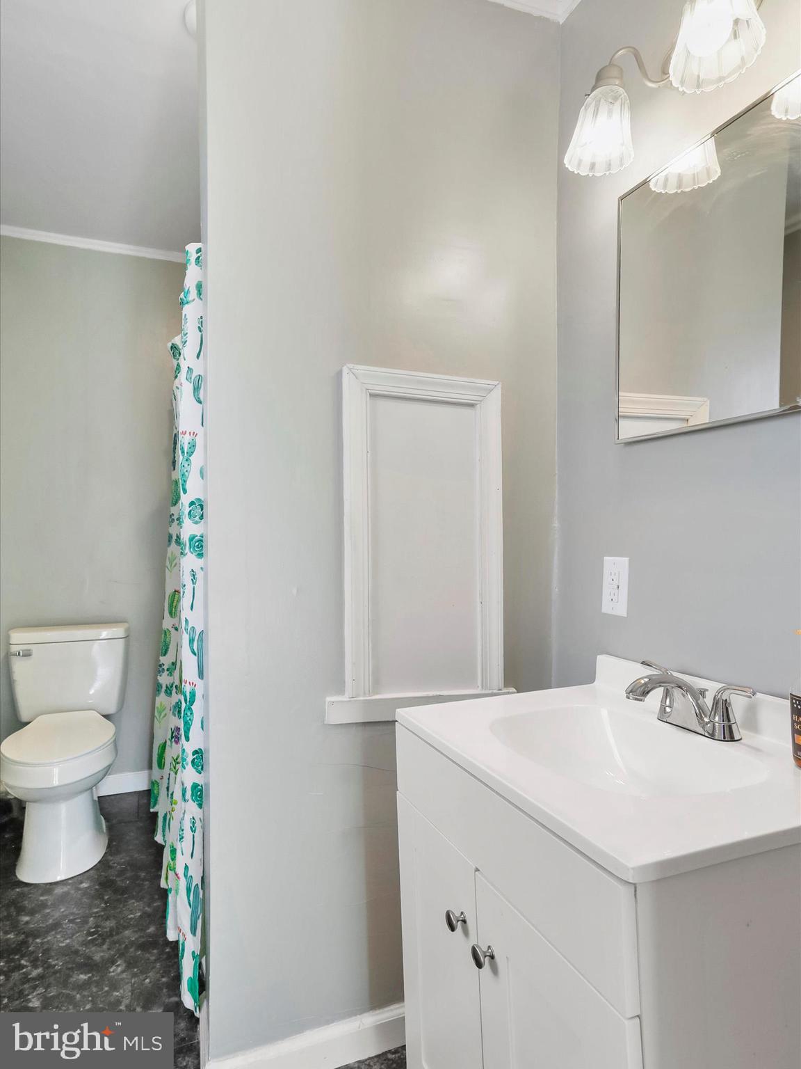 409 South Raleigh Street Martinsburg, WV 25401 - Photo 22 of 28 a bathroom with a sink and a mirror
