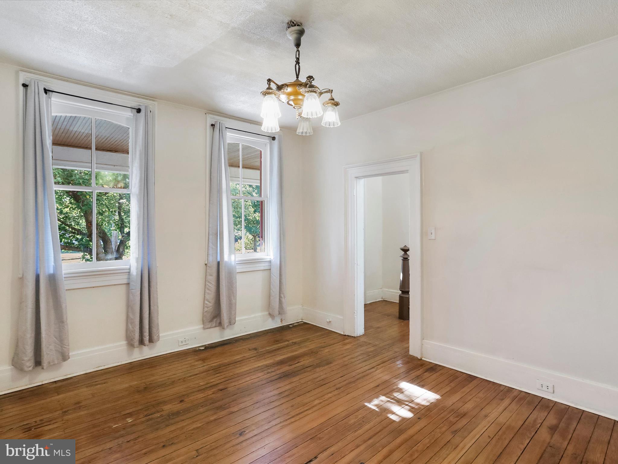 409 South Raleigh Street Martinsburg, WV 25401 - Photo 4 of 28 a view of an empty room with wooden floor and a window