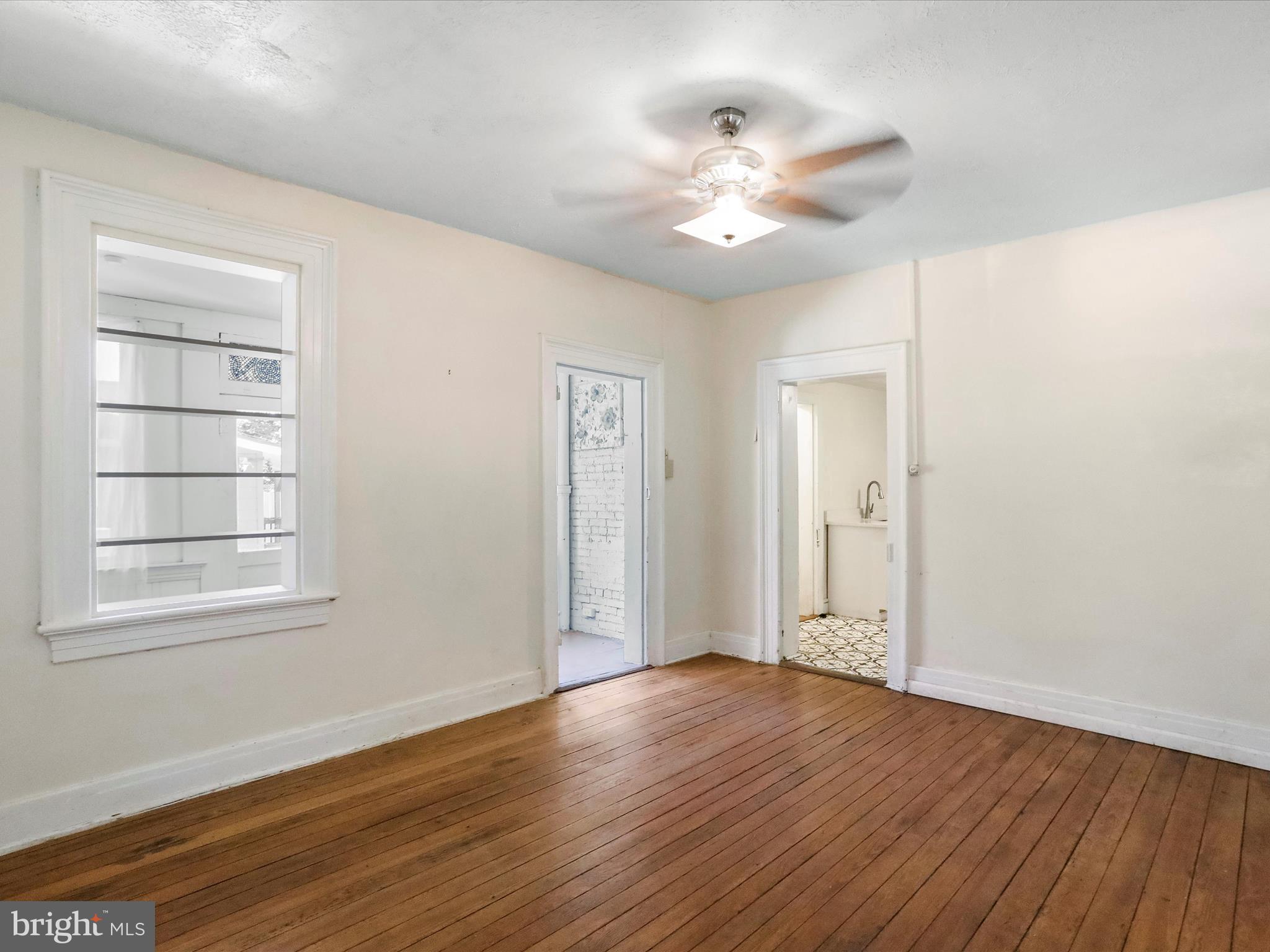 409 South Raleigh Street Martinsburg, WV 25401 - Photo 5 of 28 a view of an empty room with wooden floor and a window