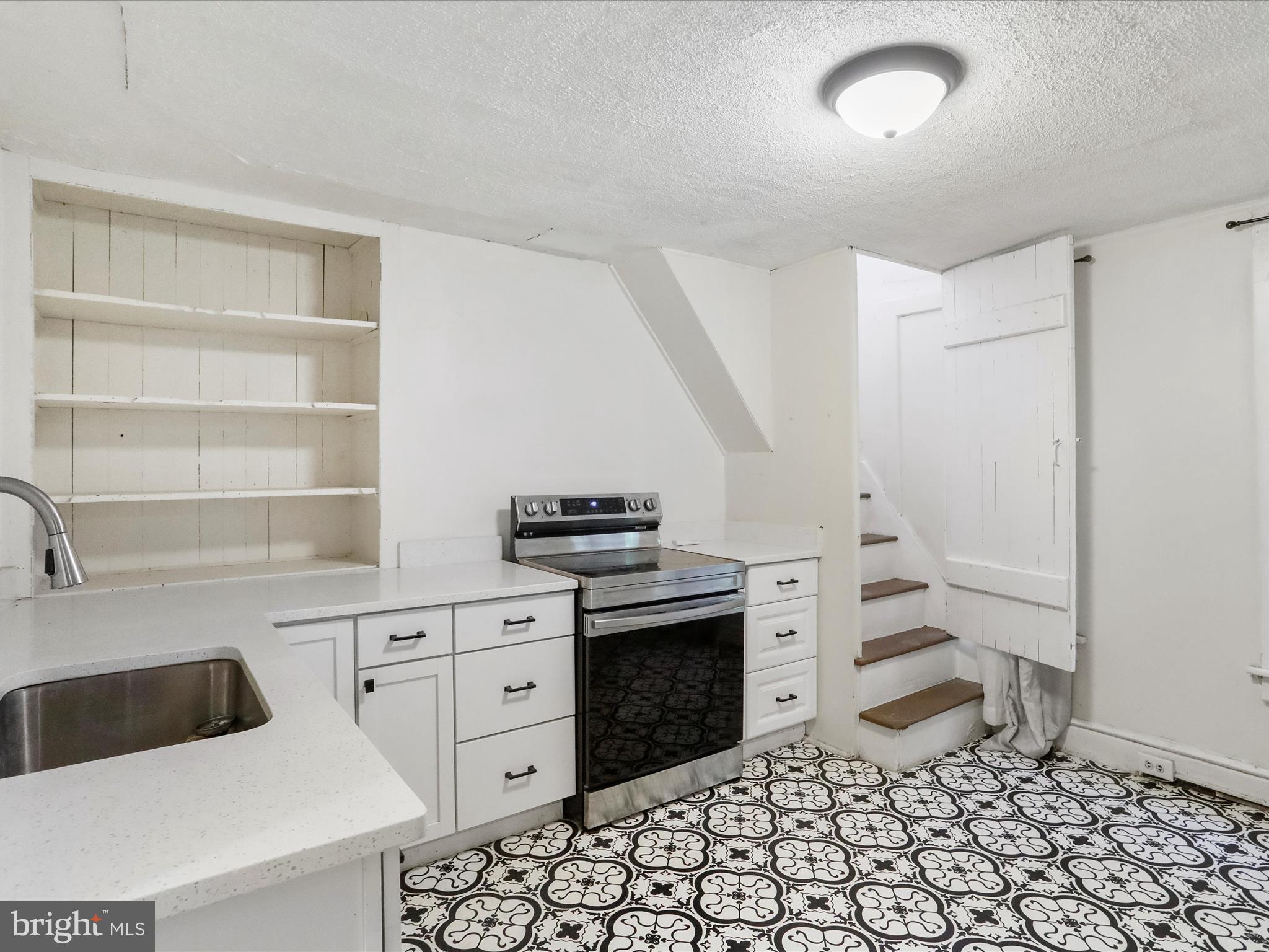 409 South Raleigh Street Martinsburg, WV 25401 - Photo 9 of 28 a kitchen with a stove a sink and a refrigerator