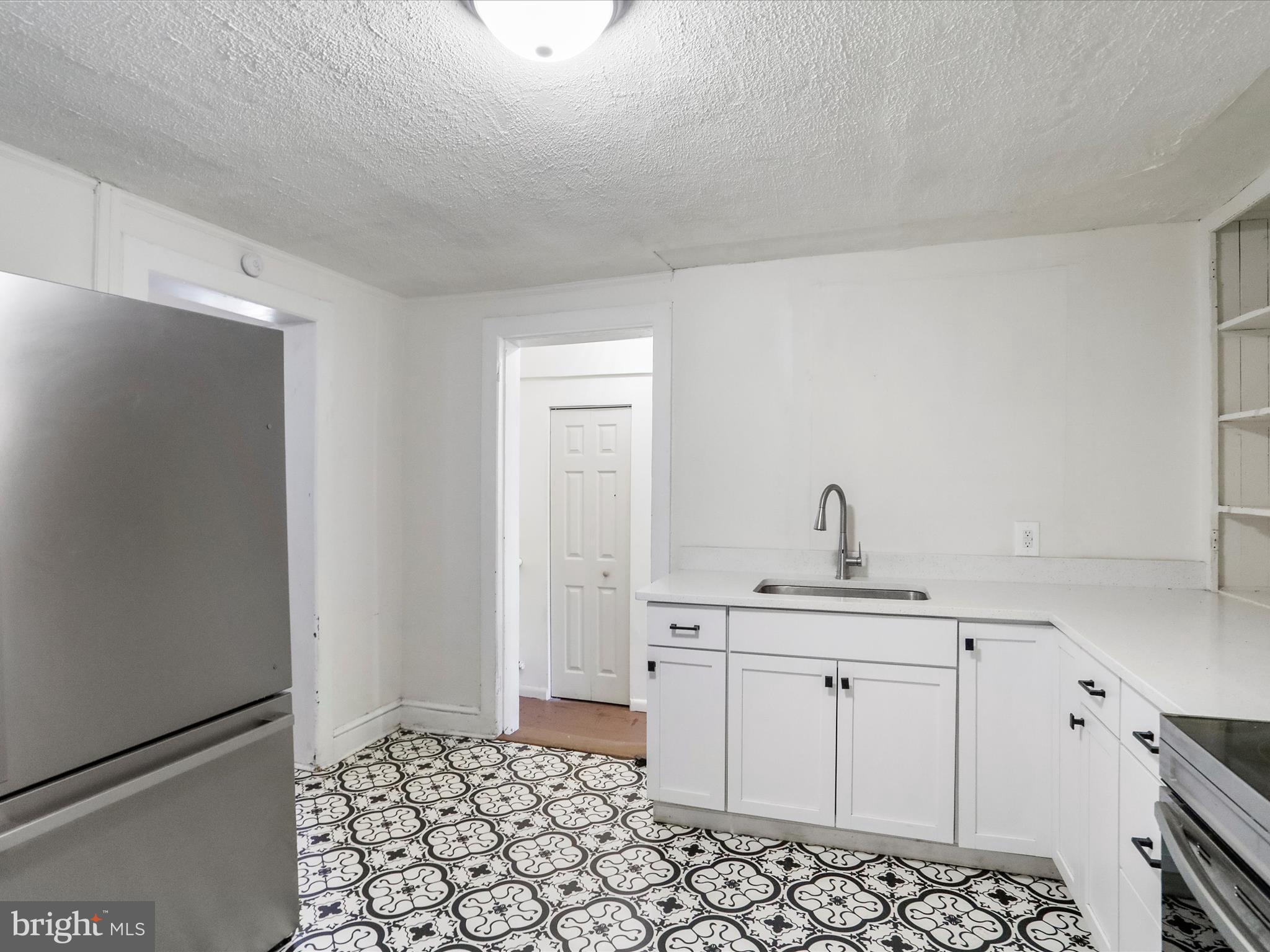409 South Raleigh Street Martinsburg, WV 25401 - Photo 10 of 28 a kitchen with a sink and cabinets