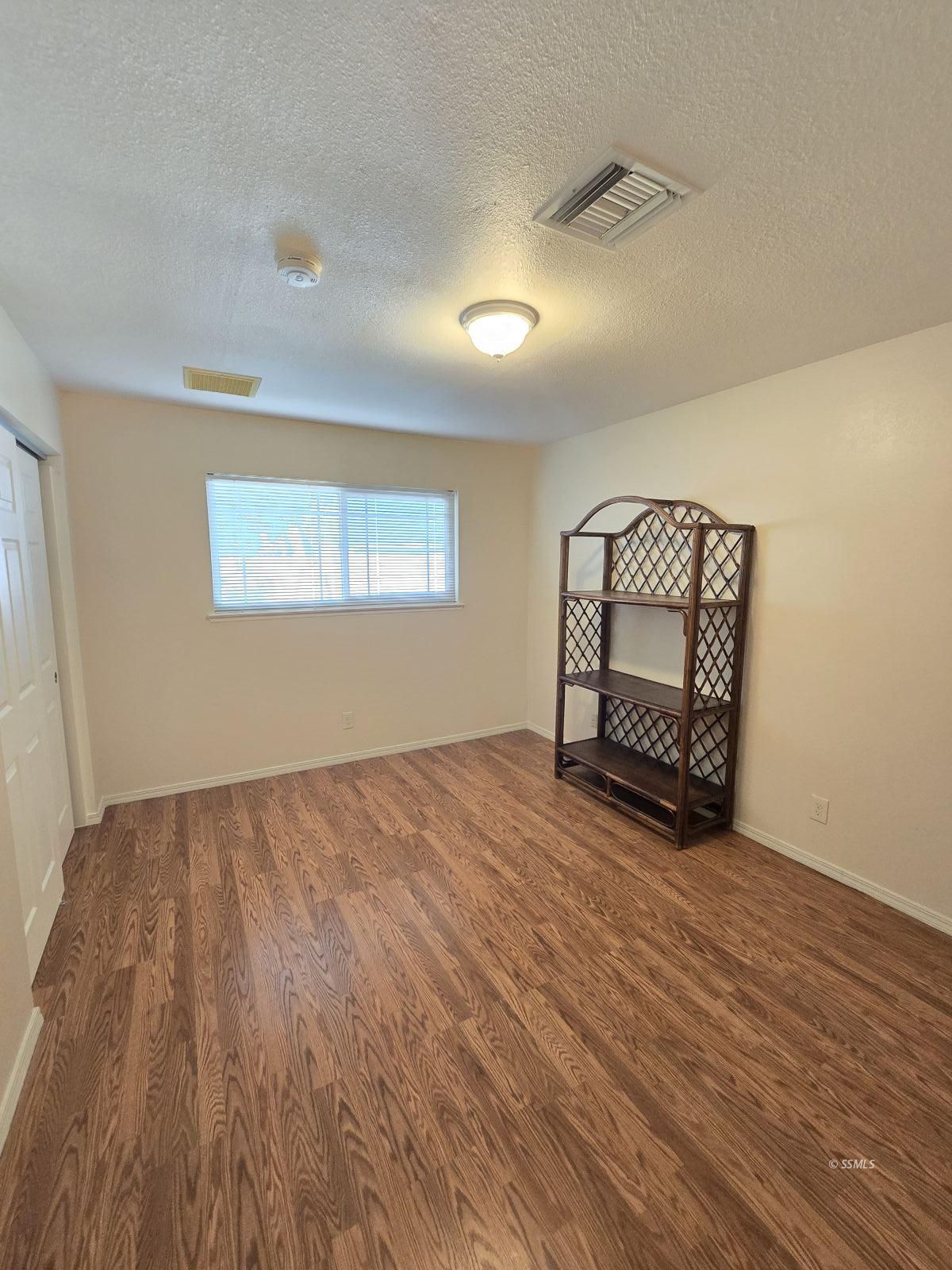 534 Suzanne Street Ridgecrest, CA 93555 - Photo 10 of 20 wooden floor in an empty room with a window