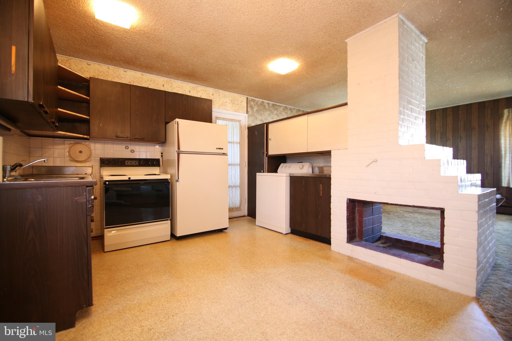 126 Gable Hill Road Levittown, PA 19057 - Photo 3 of 16 a kitchen with refrigerator and microwave