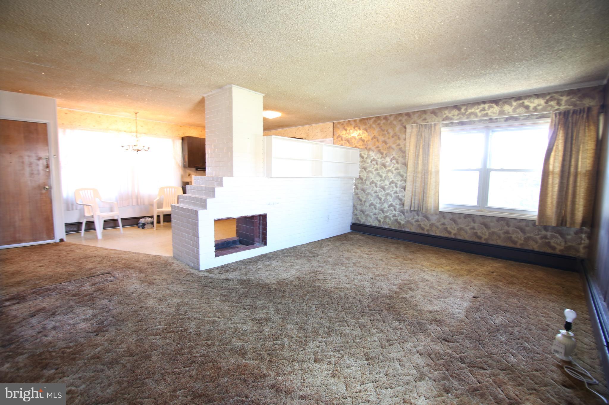 126 Gable Hill Road Levittown, PA 19057 - Photo 5 of 16 a view of an empty room with a window